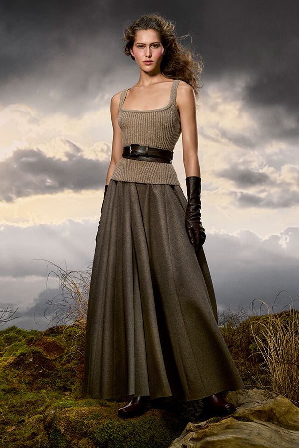 Max-Mara-Look der Kampagne Untamed Heroine mit Top, Gürtel und weitem Rock in Nussbraun mit schwarzen Handschuhen. 